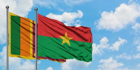 Sri Lanka and Burkina Faso flag waving in the wind against white cloudy blue sky together. Diplomacy concept, international relations.