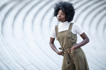 Young and beautiful black girl on an urban landscape, creative fashion shot, stairs.