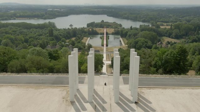 Modern architectural complex Axe Majeur on the Oise River in city of Cergy , France. Aerial shot of twelve columns de Saint-Christophe and bridge with red arches.