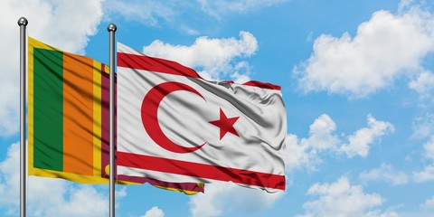 Sri Lanka and Northern Cyprus flag waving in the wind against white cloudy blue sky together....