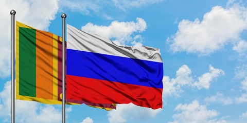 Sri Lanka and Russia flag waving in the wind against white cloudy blue sky together. Diplomacy...