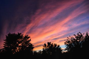 Fototapeta na wymiar crimson sunset against blue sky