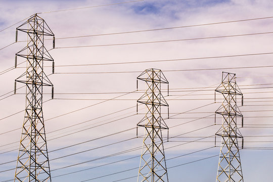 High Voltage Electricity Power Lines And Transmission Towers; Smoke Plume From The Kincaid Wildfire, Burning In Sonoma County, Northern California