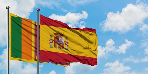 Sri Lanka and Spain flag waving in the wind against white cloudy blue sky together. Diplomacy...
