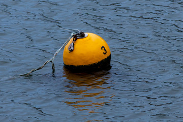 Harbour mooring buoy with the number 3 written on it