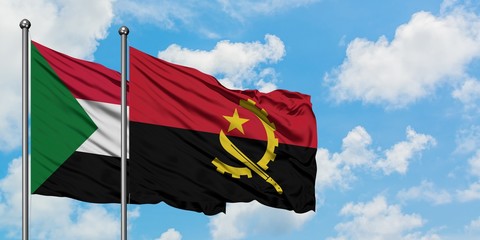 Sudan and Angola flag waving in the wind against white cloudy blue sky together. Diplomacy concept,...