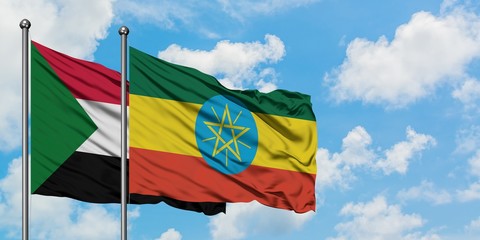 Sudan and Ethiopia flag waving in the wind against white cloudy blue sky together. Diplomacy concept, international relations.
