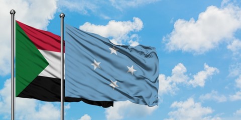 Sudan and Micronesia flag waving in the wind against white cloudy blue sky together. Diplomacy concept, international relations.