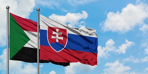 Sudan and Slovakia flag waving in the wind against white cloudy blue sky together. Diplomacy concept, international relations.