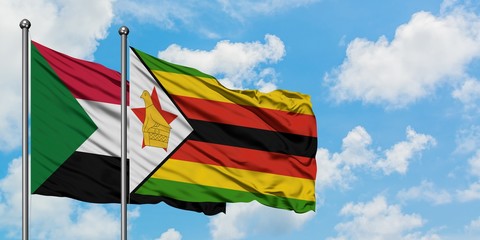 Sudan and Zimbabwe flag waving in the wind against white cloudy blue sky together. Diplomacy concept, international relations.