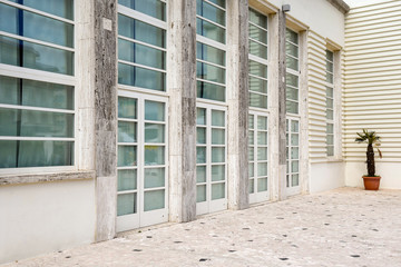 Exterior of a white building with glass door in modern architectural style, Italy