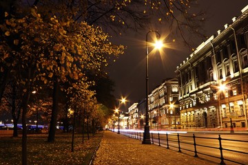 night cityscape oldtown houses and street with cars light trails