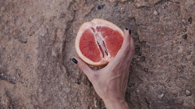 grapefruit In a female hand. isolated
