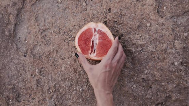 grapefruit In a female hand. isolated