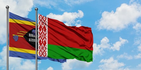 Swaziland and Belarus flag waving in the wind against white cloudy blue sky together. Diplomacy...