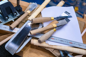 Joinery. Woodworking. Carpenter's tools. Chisels, ruler and saws are on the table in the workshop....