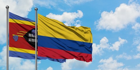 Swaziland and Colombia flag waving in the wind against white cloudy blue sky together. Diplomacy concept, international relations.