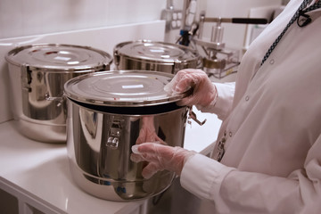 Marijuana in the pan. Cannabis inflorescences in pot in a laboratory.