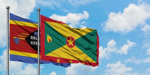 Swaziland and Grenada flag waving in the wind against white cloudy blue sky together. Diplomacy concept, international relations.