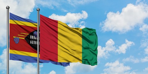 Swaziland and Guinea flag waving in the wind against white cloudy blue sky together. Diplomacy concept, international relations.