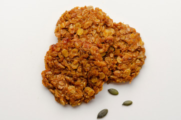 Pumpkin vegan oatmeal cookies with nuts on white background