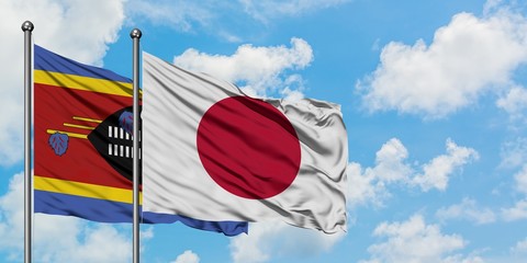 Swaziland and Japan flag waving in the wind against white cloudy blue sky together. Diplomacy concept, international relations.