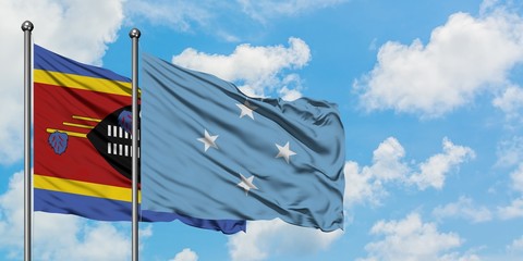 Swaziland and Micronesia flag waving in the wind against white cloudy blue sky together. Diplomacy concept, international relations.