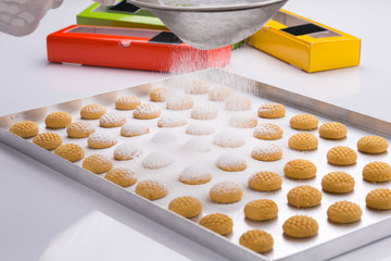 festive khak cookies dusted with powder sugar 