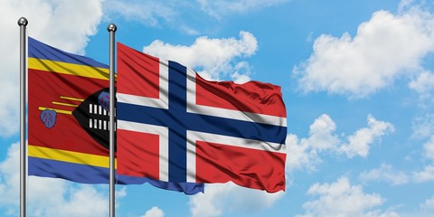 Swaziland and Norway flag waving in the wind against white cloudy blue sky together. Diplomacy concept, international relations.