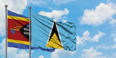 Swaziland and Saint Lucia flag waving in the wind against white cloudy blue sky together. Diplomacy concept, international relations.
