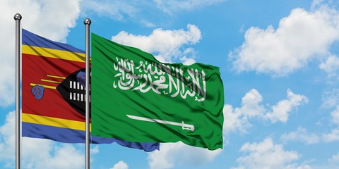 Swaziland and Saudi Arabia flag waving in the wind against white cloudy blue sky together. Diplomacy concept, international relations.