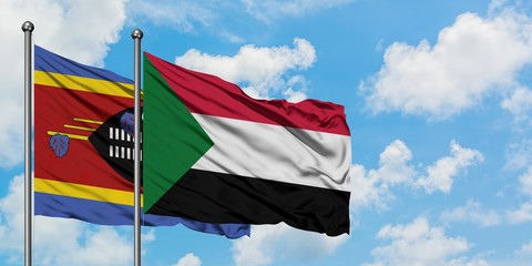 Swaziland and Sudan flag waving in the wind against white cloudy blue sky together. Diplomacy concept, international relations.