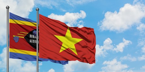 Swaziland and Vietnam flag waving in the wind against white cloudy blue sky together. Diplomacy...