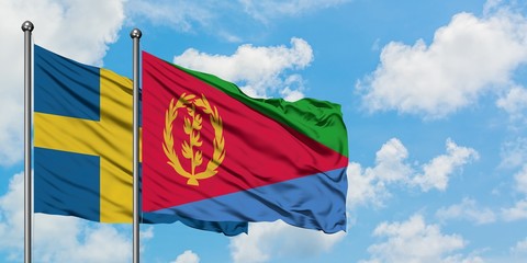 Sweden and Eritrea flag waving in the wind against white cloudy blue sky together. Diplomacy concept, international relations.