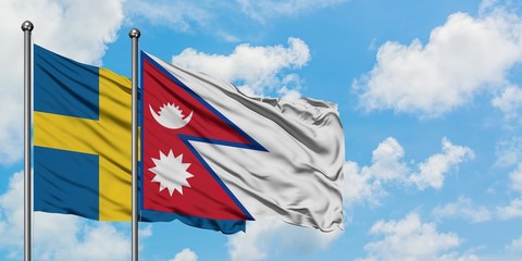Sweden and Nepal flag waving in the wind against white cloudy blue sky together. Diplomacy concept, international relations.
