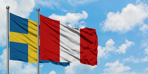 Sweden and Peru flag waving in the wind against white cloudy blue sky together. Diplomacy concept, international relations.
