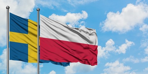 Sweden and Poland flag waving in the wind against white cloudy blue sky together. Diplomacy concept, international relations.