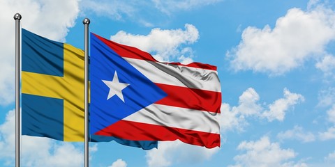 Sweden and Puerto Rico flag waving in the wind against white cloudy blue sky together. Diplomacy concept, international relations.