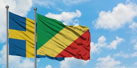 Sweden and Republic Of The Congo flag waving in the wind against white cloudy blue sky together. Diplomacy concept, international relations.