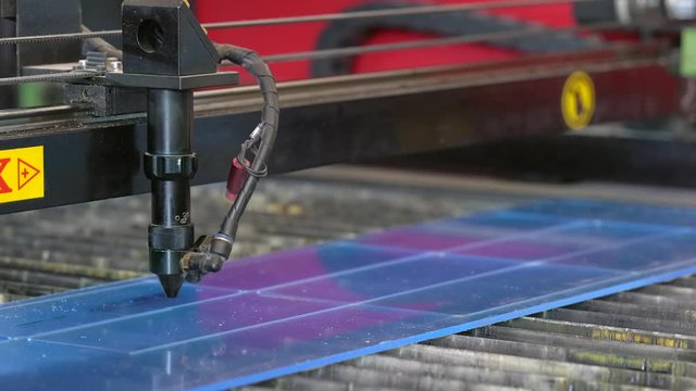 Laser cutting machine carving patterns on the plastic plate
