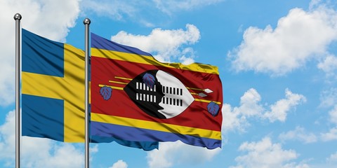 Sweden and Swaziland flag waving in the wind against white cloudy blue sky together. Diplomacy concept, international relations.