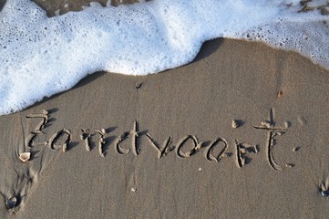 Zandvoort written on sandy beach on a North Sea in the Netherlands on Zandvoort beach - obrazy, fototapety, plakaty