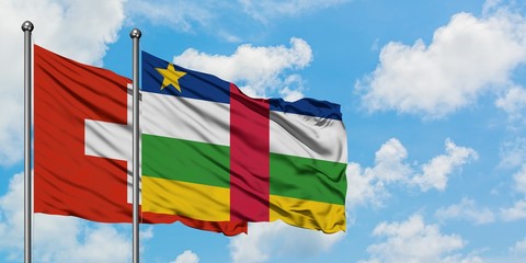 Switzerland and Central African Republic flag waving in the wind against white cloudy blue sky together. Diplomacy concept, international relations.