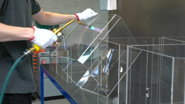 Man heating the plastic with the gas torch