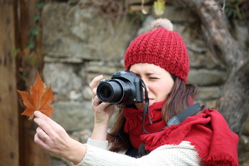 Young beautiful woman taking pictures to beech leaves in one of the most amazing beech forest in Europe, "La Fageda d'en Jorda", a nature paradise placed close to Olot village, Catalonia, Spain.