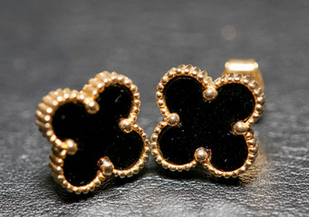 Small black clover earrings on white background. - Image