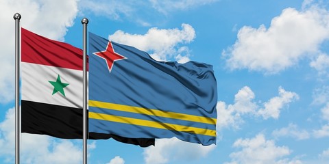 Syria and Aruba flag waving in the wind against white cloudy blue sky together. Diplomacy concept, international relations.