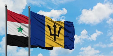 Syria and Barbados flag waving in the wind against white cloudy blue sky together. Diplomacy concept, international relations.