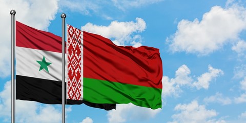 Syria and Belarus flag waving in the wind against white cloudy blue sky together. Diplomacy...