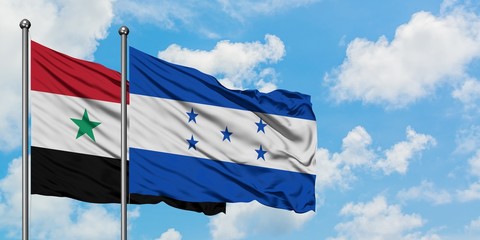 Syria and Honduras flag waving in the wind against white cloudy blue sky together. Diplomacy...